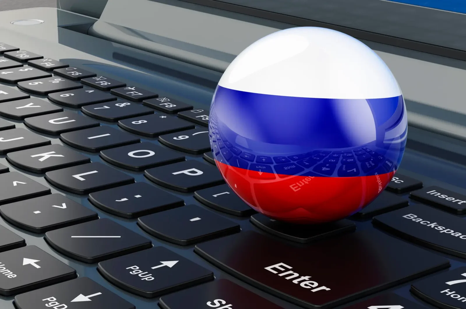3D globe painted with the Russian flag sits on a laptop keyboard, symbolizing cyber geopolitics or tech diplomacy.